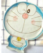 Japanese ceramic dinnerware set with hand-drawn cat design on blue rectangular plate and bowl