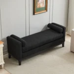 Goldoma upholstered bench daybed ottoman with wood legs and two bolster pillows in a modern living room setting