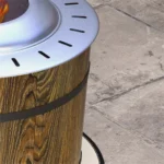 Brown fire pit with glowing flames in a backyard setting