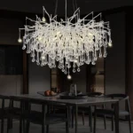 Modern crystal chandelier in black chrome and gold with raindrop crystals hanging in a living room