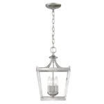 HMS vintage silver hanging light illuminated in a modern living room with neutral decor, emphasizing its classic appeal.