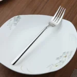 Goldoma 24-piece stainless steel cutlery set on a wooden table