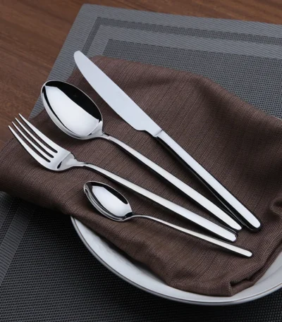 Goldoma 24-piece stainless steel cutlery set on a wooden table