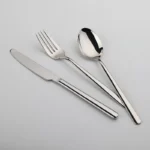 Goldoma 24-piece stainless steel cutlery set on a wooden table