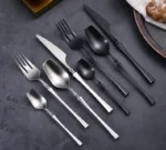 Matte black gold flatware set arranged on a table, showcasing elegant cutlery