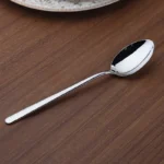 Goldoma 24-piece stainless steel cutlery set on a wooden table