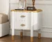 Curved nightstand with drawers featuring feather handles in a modern bedroom setting