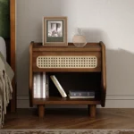 Walnut nightstand with rattan detail featuring a drawer and open shelf in a modern bedroom setting