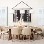 Oval rectangle ceiling light with white shade and metal frame, suspended at different heights over a living room sofa.