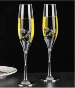 Elegant crystal champagne glasses set on a table with sparkling wine