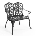 Outdoor metal bench with floral rose design in black finish on a patio