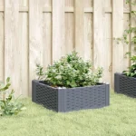 Blue grey polypropylene medium garden planter with flowers on patio