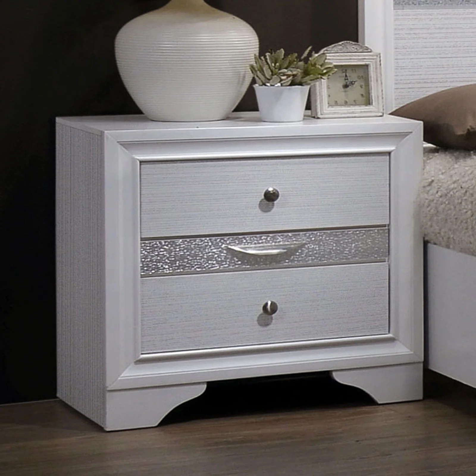 Ha610b64c887c4f8aa037035325af8152W.webp White nightstand with hidden drawer and nickel knobs beside a bed in a modern bedroom