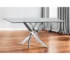 Modern rectangular glass dining table with clear tempered glass top and silver stainless steel pedestal base in a bright