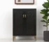 Modern rustic bar cabinet with black gold finish and faux rattan accents in a living room setting