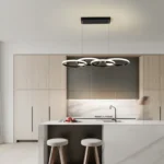Overhead shot of the 4-Ring LED Pendant Light with rings in matte black, casting soft shadows on a dining set.