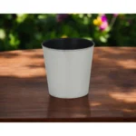 Large silver planter with a thriving houseplant on a modern table