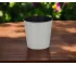 Large silver planter with a thriving houseplant on a modern table