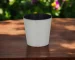 Large silver planter with a thriving houseplant on a modern table