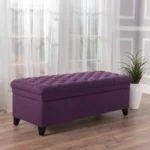 Purple fabric storage ottoman with hidden compartment and birch wood legs in a living room