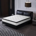 Goldoma 12-inch hybrid queen mattress with memory foam and pocketed coils in medium firmness, displayed on a bed frame