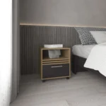 Modern rolling nightstand with one drawer and shelf in natural oak and black finish, placed beside a bed