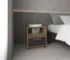 Goldoma rolling nightstand with drawer in natural oak and black beside a bed