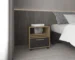 Goldoma rolling nightstand with drawer in natural oak and black beside a bed