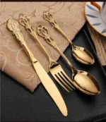 24-piece stainless steel cutlery set with gold handles displayed on a wooden table