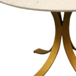 Elegant round marble dining table with ivory marble top and brass pedestal base in a modern dining room