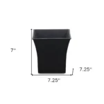 HMS 7 black recycled plastic pot planter placed on a patio with outdoor cushions and potted plants