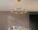Modern ring chandelier in gold finish illuminating a living room