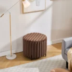 Goldoma faux fur pouf ottoman with black metal legs in a modern living room setting