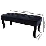 Mid-century velvet ottoman with wood legs in black - Goldoma