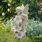 Solar fairy statue glowing in a garden at dusk