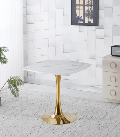 Modern square dining table with marble top and gold metal base in a small apartment dining room