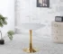 Modern square marble dining table with gold metal base in a bright dining room