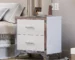 Modern mirrored nightstand 2 drawers with high-gloss finish and chrome handles beside a bed