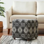 Goldoma gray cube ottoman with wood base and brown faux leather sides, used as a footrest