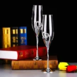 Elegant crystal champagne glasses set on a table with sparkling wine