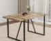 Modern dining table with textured MDF top and black metal legs in a minimalist dining room