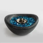 Black concrete mini tabletop fire pit with smokeless ethanol flame on a wooden table
