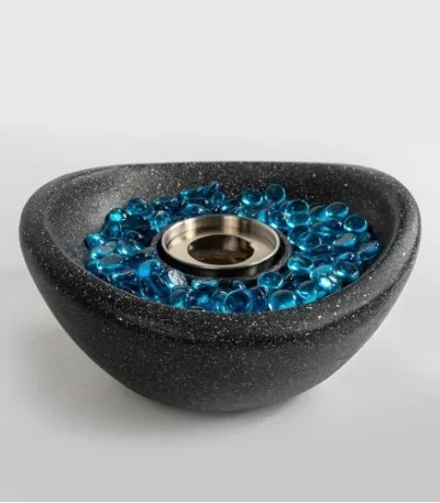 Black concrete mini tabletop fire pit with smokeless ethanol flame on a wooden table