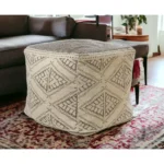 Goldoma 20-inch beige cotton tribal pouf ottoman with tufted stitching used as foot rest in living room