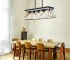 Goldoma 32-inch black and white 5-light pendant chandelier with modern metal cage design, hanging from ceiling in a