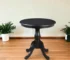 30 inch round dining table with black pedestal base in a modern dining room