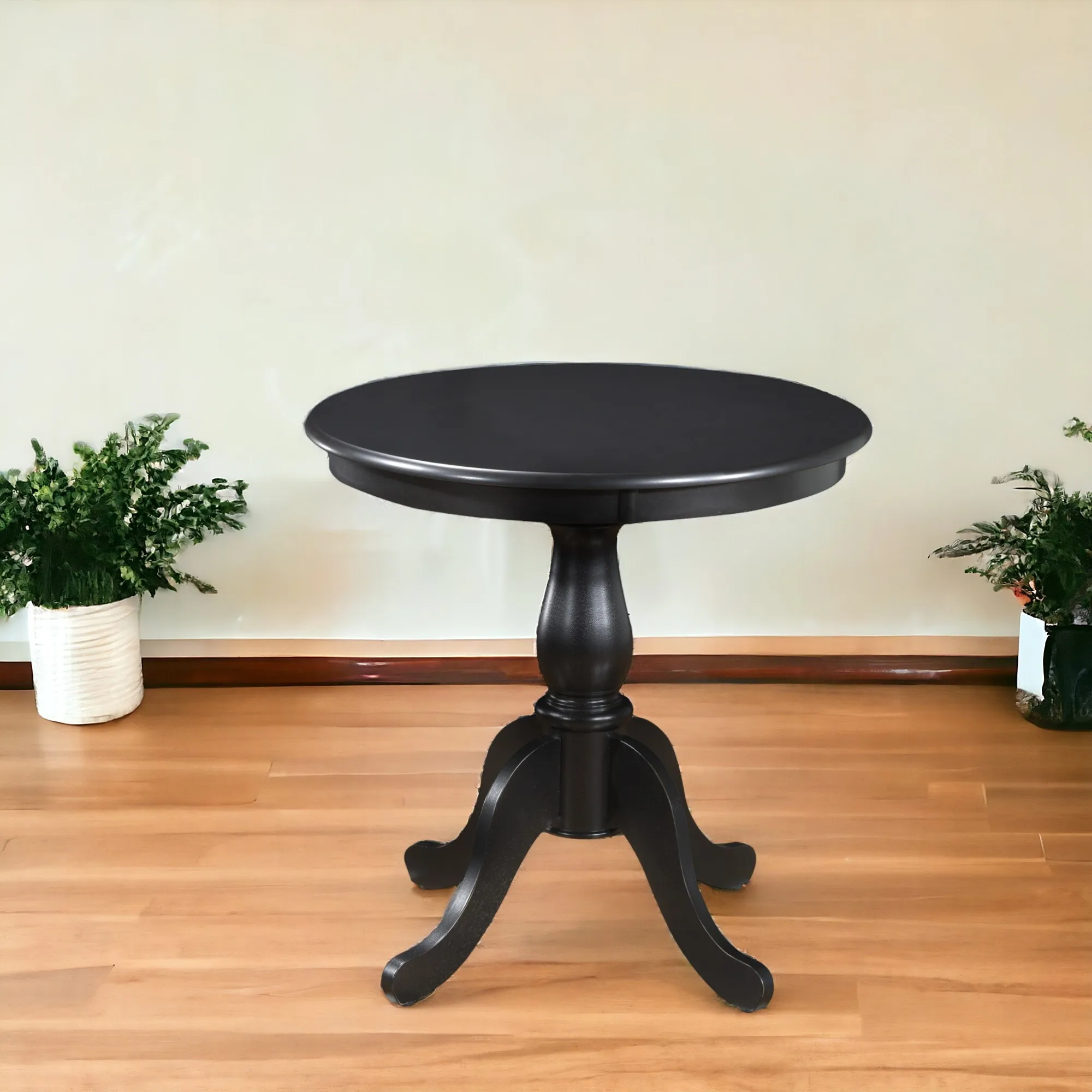 30 inch round dining table with black pedestal base in a modern dining room