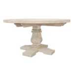 Round solid wood dining table with natural finish and pedestal base in a modern dining room