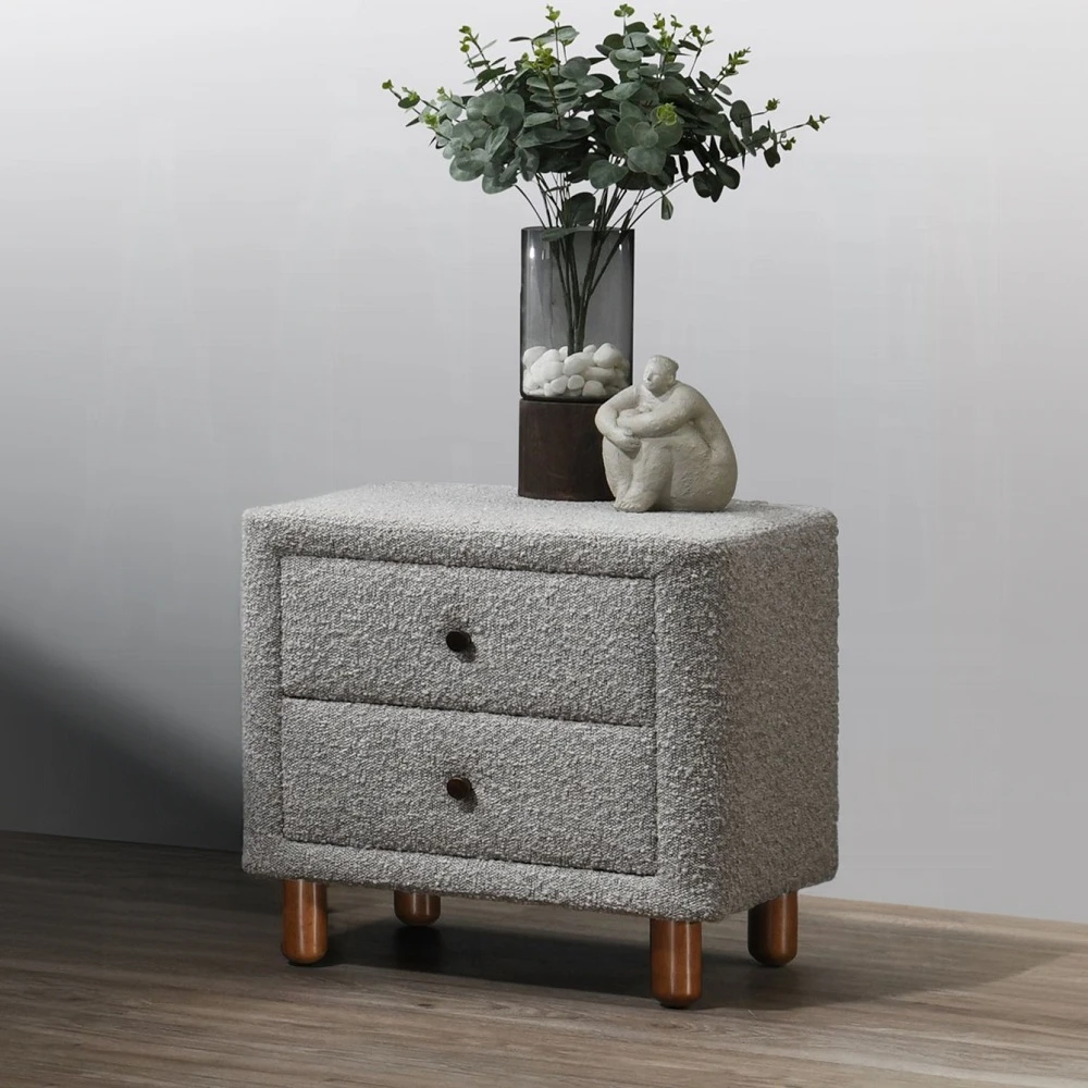 Hb3acf3b43dc04926babc3eafad99c6c1o.webp Gray boucle nightstand with two drawers and wooden legs in a modern bedroom setting