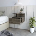 Dark walnut floating nightstand one drawer wall-mounted beside a bed in a modern bedroom